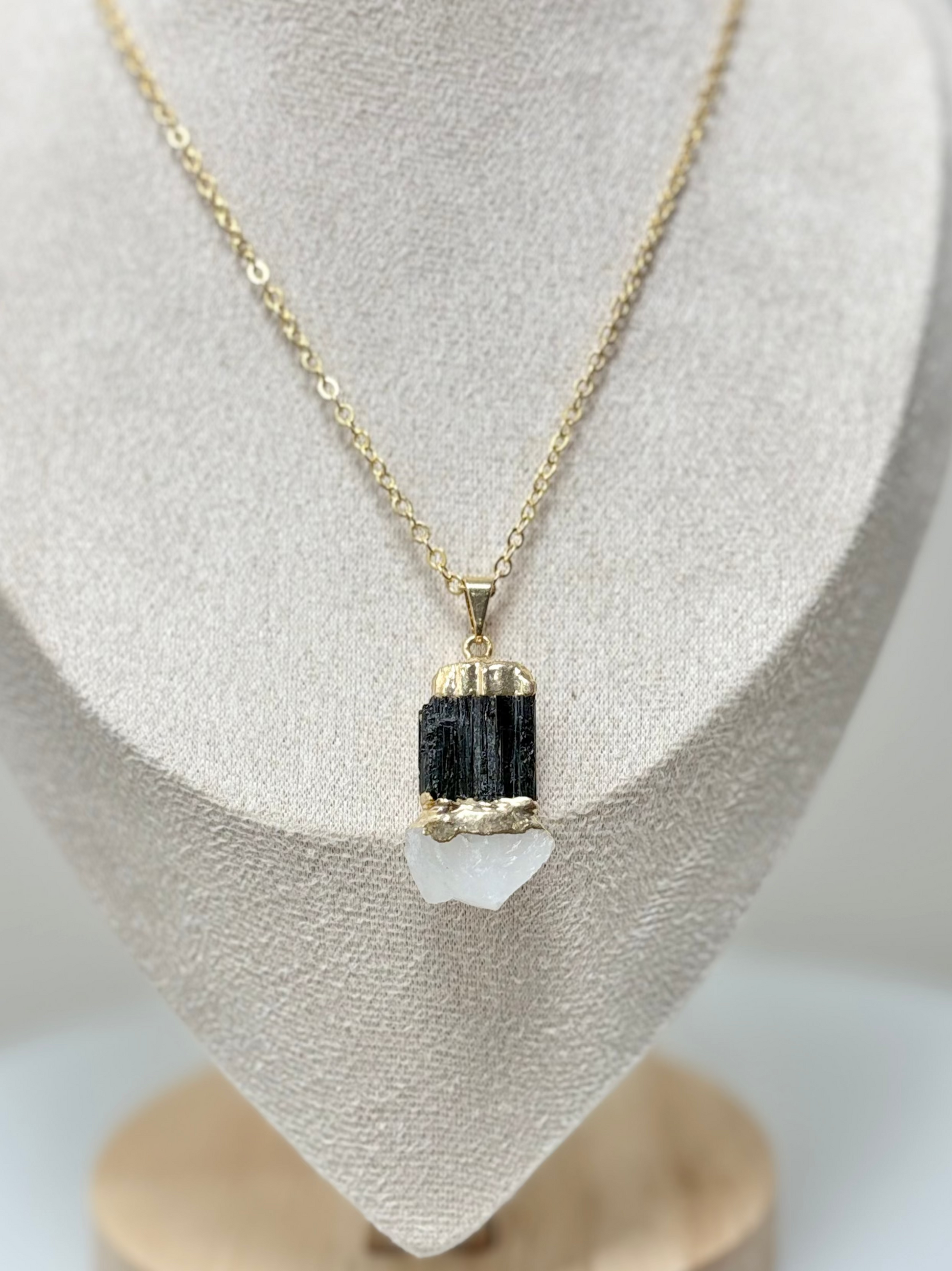 Close-up of bonded black tourmaline and clear quartz crystals on gold plated chain AquaBrasil jewelry