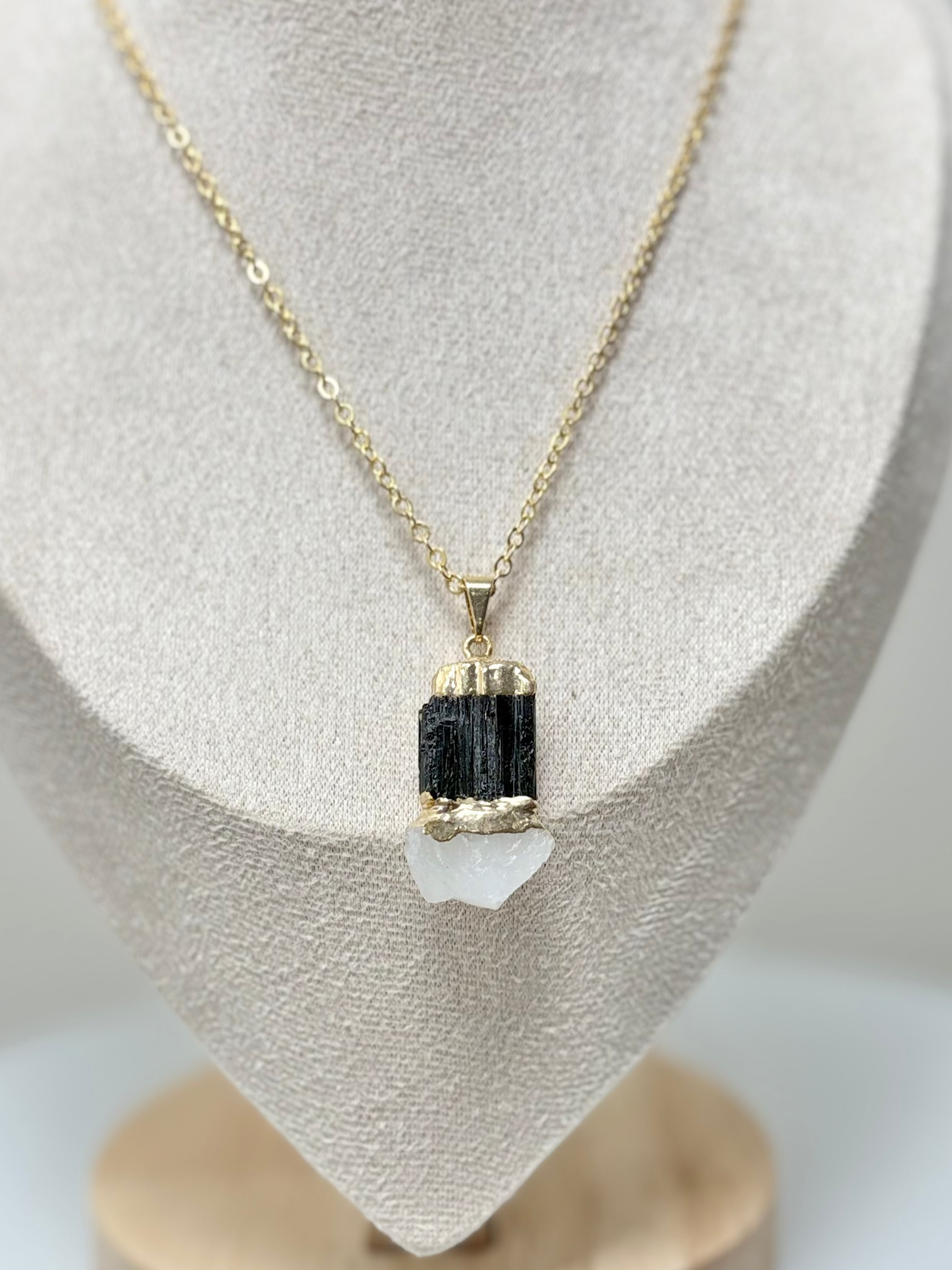 Close-up of bonded black tourmaline and clear quartz crystals on gold plated chain AquaBrasil jewelry
