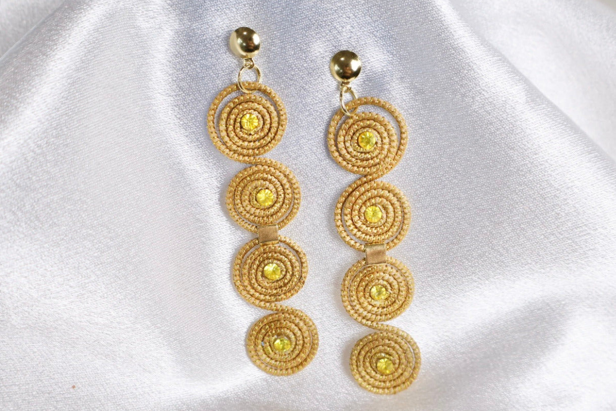 close up of Carnaval golden grass earrings with crystal accents handcrafted in Brazil AquaBrasil jewelry
