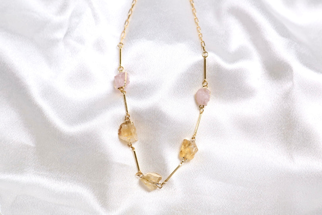 Close up of stones raw citrine and rose quartz necklace AquaBrasil