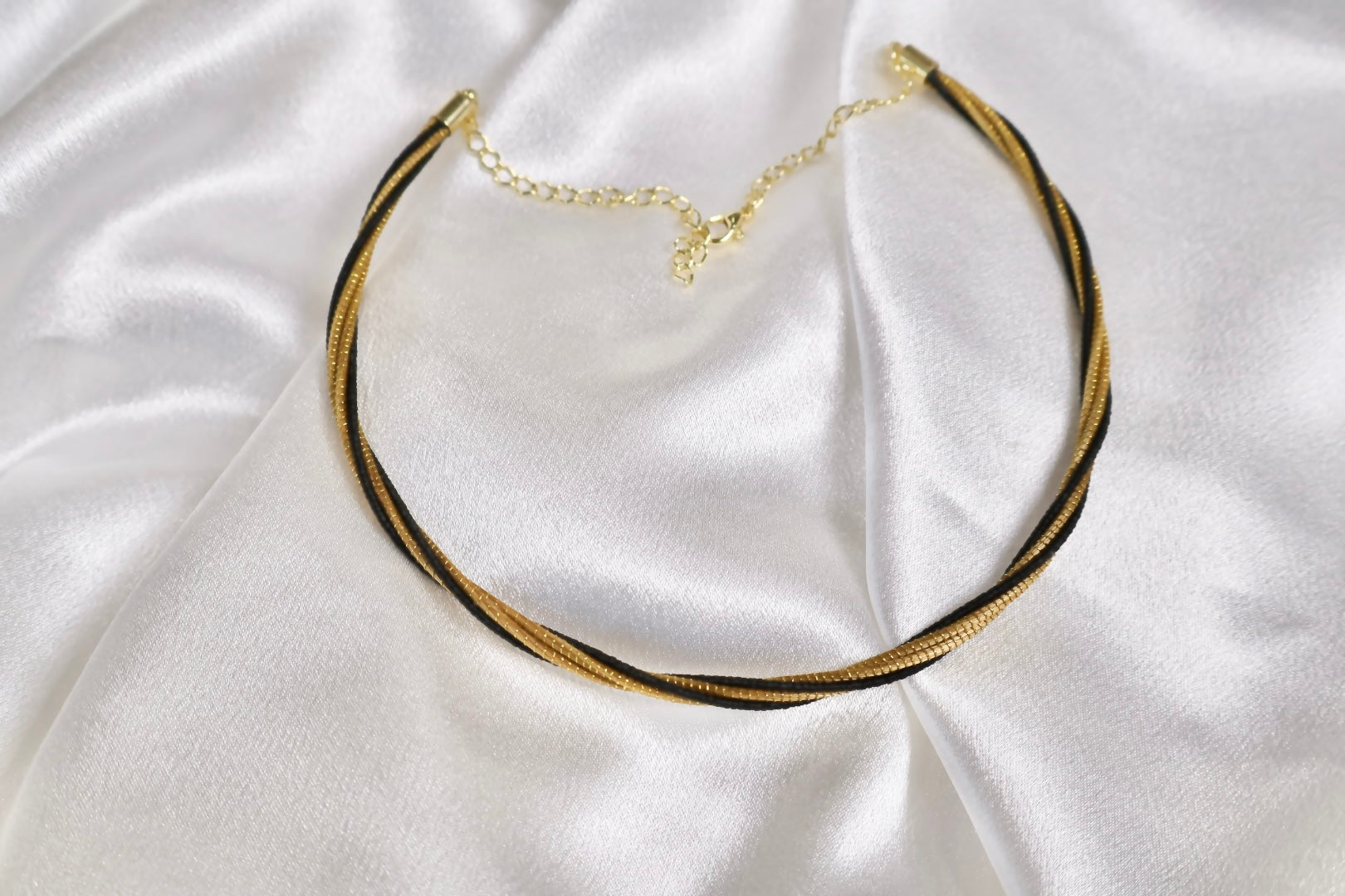 golden grass twisted choker with black thread and gold plated chain displayed flat AquaBrasil