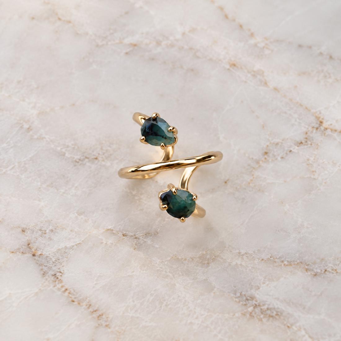 Double natural Emerald spiral ring with two pear-shaped faceted gemstones and adjustable 18K gold-plated band