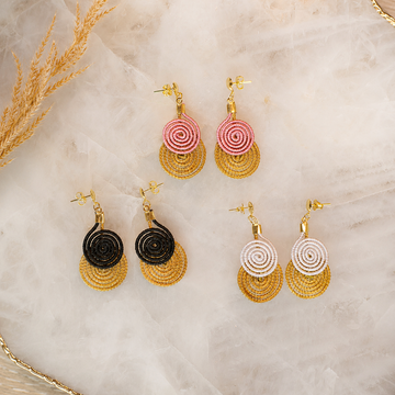 Handwoven Golden Grass spiral drop earrings with 18K gold dipped details available in blush pink, ivory, and black.