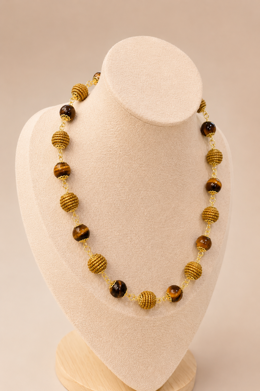 Natural Tiger Eye and handwoven Brazilian golden grass beaded necklace with 18K gold-plated details