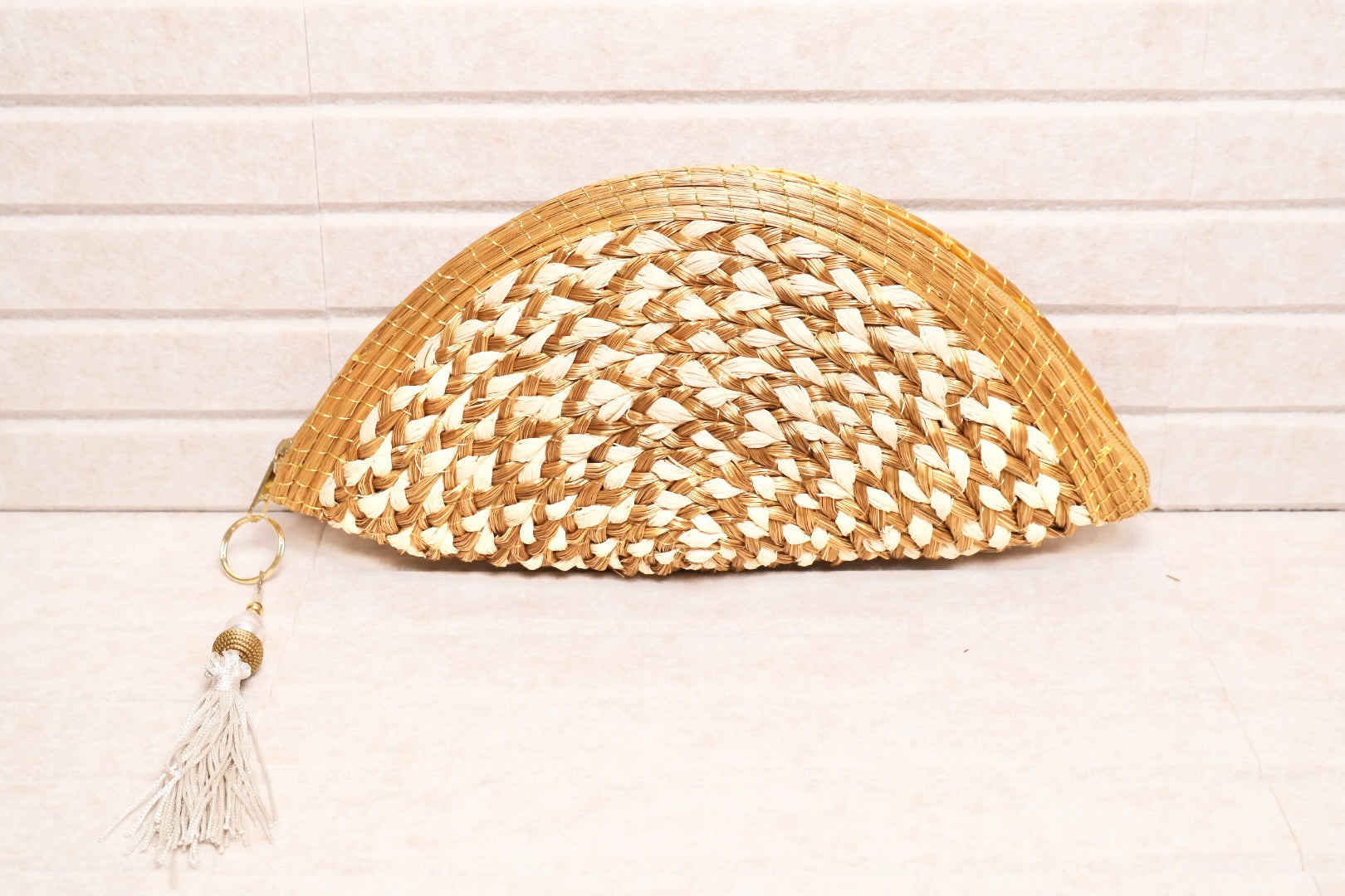 golden grass and buriti clutch with pearl accent charm and zipper closure AquaBrasil