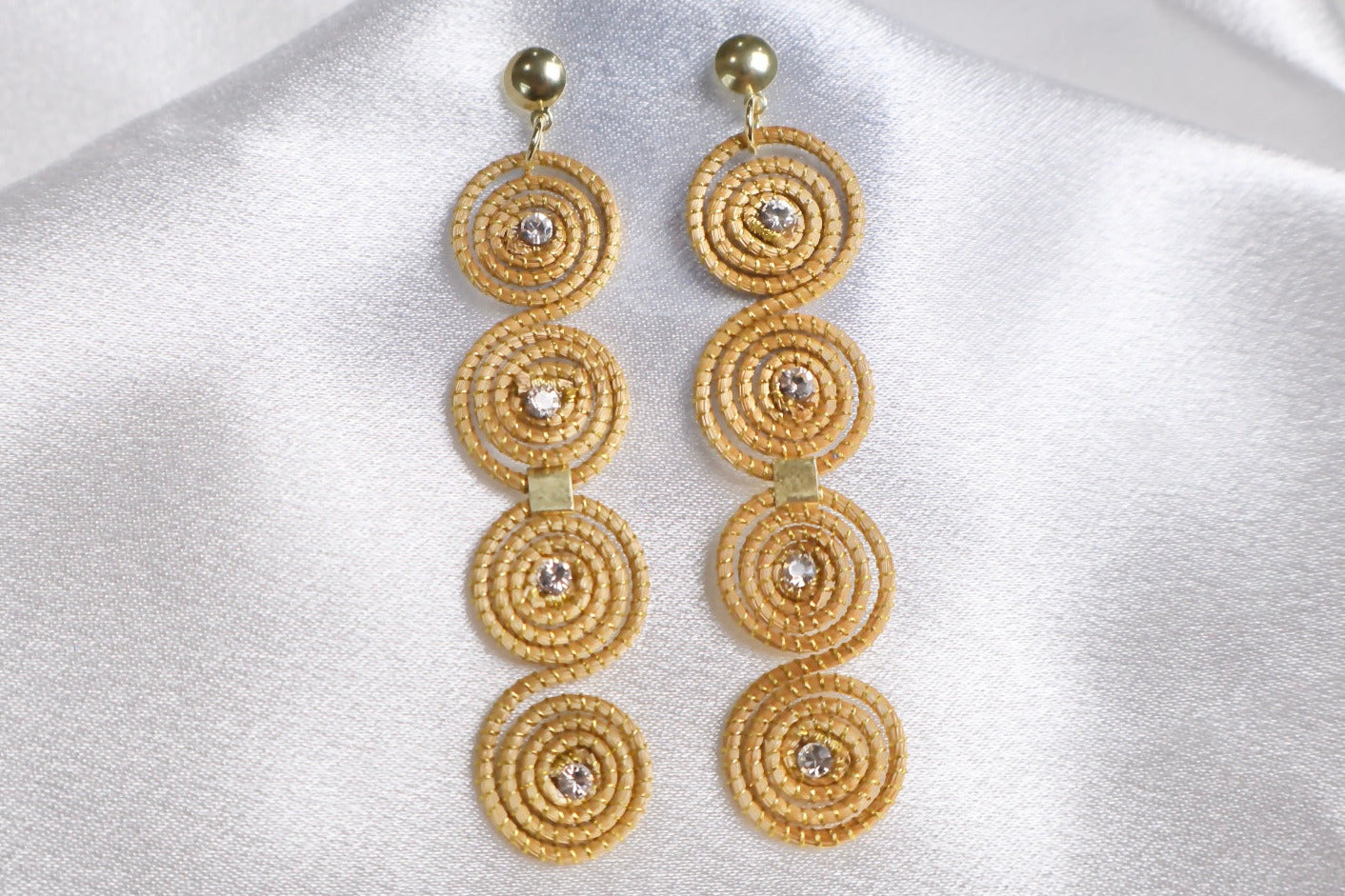 close up of Carnaval golden grass earrings with crystal accents handcrafted in Brazil AquaBrasil jewelry