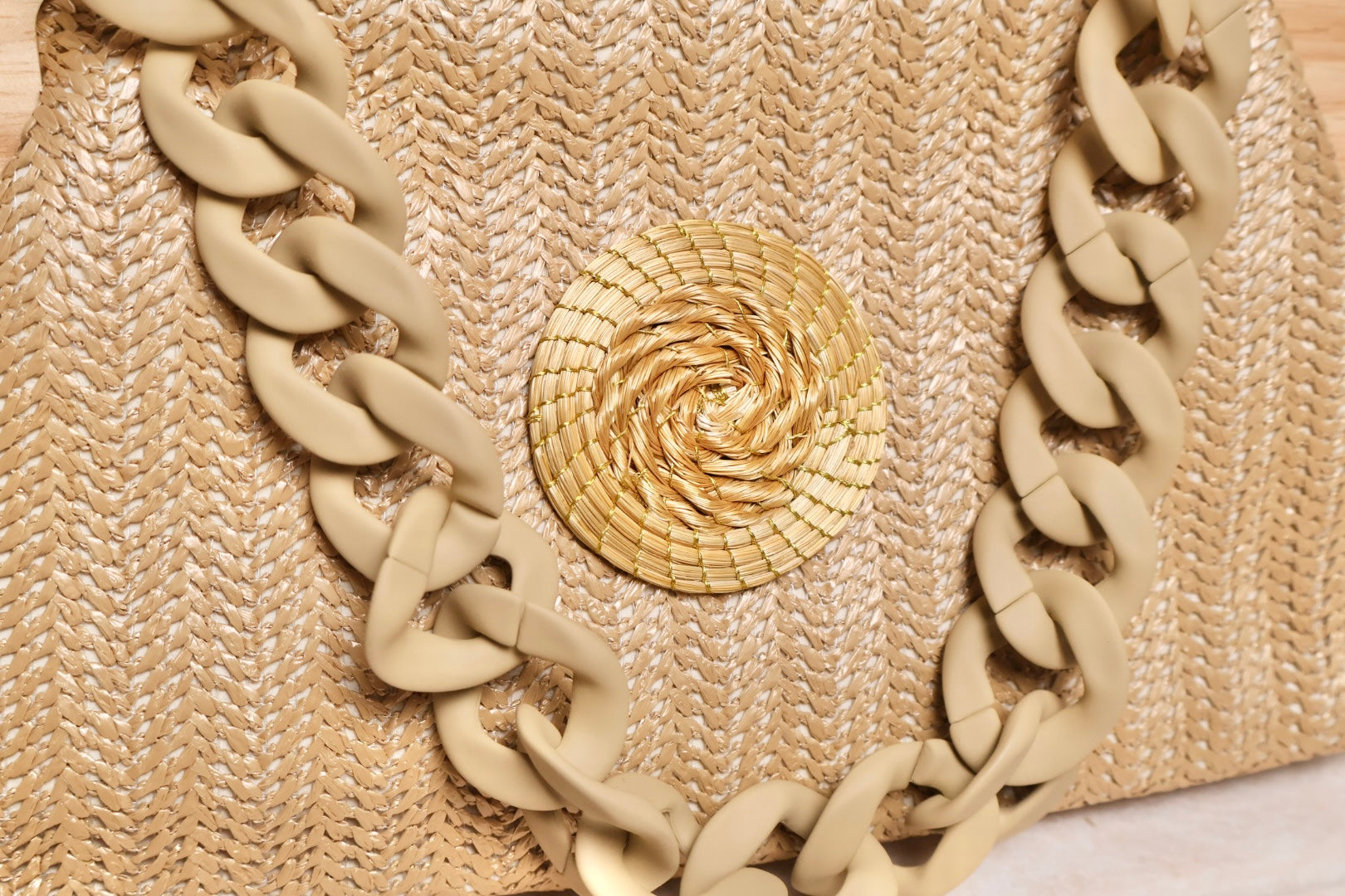 close up of golden grass mandala detail on woven bag with wood handle AquaBrasil