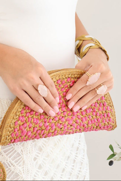 model wearing two rose quartz marquise shaped facet rings