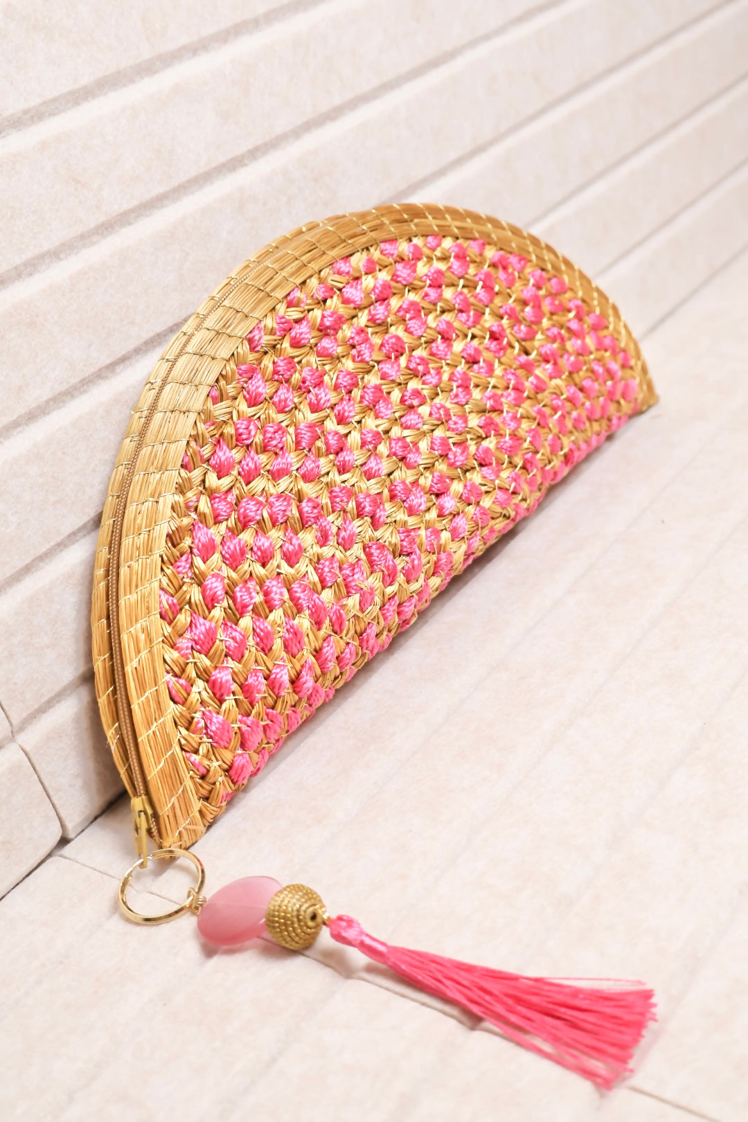 half moon golden grass clutch with pink crochet detail and zipper closure AquaBrasil
