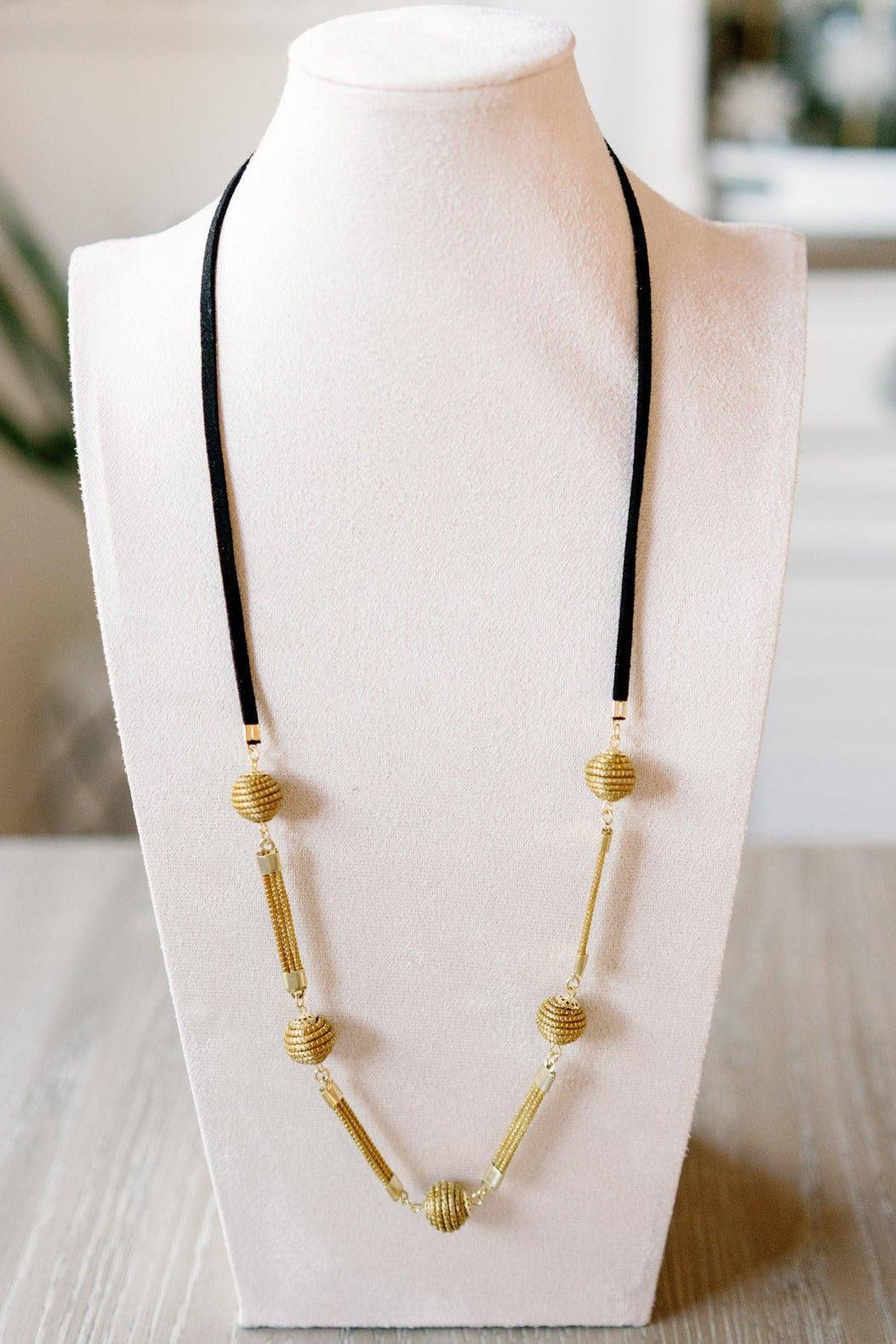 sol necklace handcrafted with golden grass beads and black suede cord long statement design by AquaBrasil